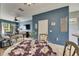Inviting dining area with a glass table, comfortable seating, and blue accent wall at 13905 Abbey Ln, Largo, FL 33771