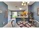 Open dining area with a glass table, adjacent to the kitchen and offering backyard views at 13905 Abbey Ln, Largo, FL 33771