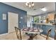 Cozy dining area features a glass table with seating for four and stylish decor at 13905 Abbey Ln, Largo, FL 33771