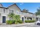 Charming townhome featuring manicured landscaping, a well-lit walkway, and neutral exterior paint at 13905 Abbey Ln, Largo, FL 33771