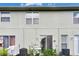 A view of the rear exterior showing the patio, lawn, and AC units at 13905 Abbey Ln, Largo, FL 33771