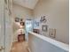 Upstairs hallway featuring neutral walls adorned with artwork and a decorative bicycle at 13905 Abbey Ln, Largo, FL 33771