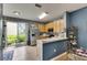 Bright kitchen with stainless steel appliances and a breakfast bar overlooking the dining area at 13905 Abbey Ln, Largo, FL 33771