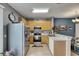 Modern kitchen featuring stainless steel appliances, wooden cabinets, and tiled flooring at 13905 Abbey Ln, Largo, FL 33771
