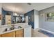 Bright kitchen with a stainless steel sink and view of the dining and living areas at 13905 Abbey Ln, Largo, FL 33771