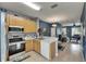 Bright kitchen with stainless steel appliances, and a view of the adjoining living area at 13905 Abbey Ln, Largo, FL 33771