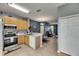 Spacious kitchen with modern appliances, tiled backsplash, and an open layout to the living area at 13905 Abbey Ln, Largo, FL 33771
