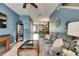 Bright living room with comfortable seating, blue walls, and an open floor plan at 13905 Abbey Ln, Largo, FL 33771