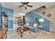 Bright living room with comfortable seating, blue walls, and an open floor plan at 13905 Abbey Ln, Largo, FL 33771