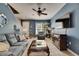 Bright living room with comfortable seating, blue walls, and an open floor plan at 13905 Abbey Ln, Largo, FL 33771