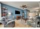 Bright living room with comfortable seating, blue walls, and an open floor plan at 13905 Abbey Ln, Largo, FL 33771