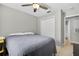 Bedroom with tiled floors, ceiling fan, closet, and en suite bathroom at 1400 Gandy N Blvd # 809, St Petersburg, FL 33702