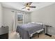 Bedroom featuring tile floors, a ceiling fan, and natural light from the window at 1400 Gandy N Blvd # 809, St Petersburg, FL 33702