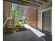 Apartment entryway showcasing secure stairs and door entrance, accented by landscape and brickwork at 1400 Gandy N Blvd # 809, St Petersburg, FL 33702