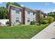 Charming two-story condo building with brick accents, gray siding, and well-maintained landscaping at 1400 Gandy N Blvd # 809, St Petersburg, FL 33702