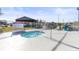Relaxing outdoor hot tub enclosed by a fence with lounge chairs nearby at 1400 Gandy N Blvd # 809, St Petersburg, FL 33702