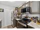 Cozy kitchen features stainless steel appliances, upper cabinets, and white marble countertops at 1400 Gandy N Blvd # 809, St Petersburg, FL 33702