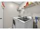 Bright laundry room featuring a modern washer and dryer, with convenient overhead storage shelving at 1400 Gandy N Blvd # 809, St Petersburg, FL 33702