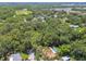 Aerial view of a home nestled in the lush greenery of the surrounding trees at 1402 E Mimosa Dr, Plant City, FL 33563