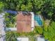 Aerial view of a house with a pool, surrounded by trees and lush greenery at 1402 E Mimosa Dr, Plant City, FL 33563