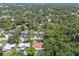 Aerial view of houses nestled amongst beautiful, mature trees in a quiet neighborhood at 1402 E Mimosa Dr, Plant City, FL 33563