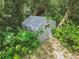 A greenhouse tucked amidst lush greenery, offering a haven for plant enthusiasts at 1402 E Mimosa Dr, Plant City, FL 33563