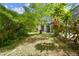 View of the grassy backyard showing the landscaping and shed with separate doors at 1402 E Mimosa Dr, Plant City, FL 33563