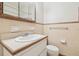 Bathroom featuring a sink, toilet, tiled walls, offering a practical space at 1402 E Mimosa Dr, Plant City, FL 33563