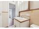 Neutral bathroom featuring a vanity with white sink, tile backsplash and view to an adjacent room at 1402 E Mimosa Dr, Plant City, FL 33563