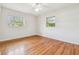 Spacious, bright bedroom with hardwood floors, ceiling fan and two windows for natural light at 1402 E Mimosa Dr, Plant City, FL 33563