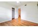 Bedroom with hardwood floors, ceiling fan, and closet space at 1402 E Mimosa Dr, Plant City, FL 33563