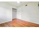 Bedroom featuring hardwood floors and spacious closet at 1402 E Mimosa Dr, Plant City, FL 33563