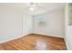 Bedroom featuring hardwood floors, fan and closet with sliding doors at 1402 E Mimosa Dr, Plant City, FL 33563