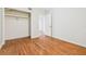 Bedroom with hardwood floors and closet, featuring a bright and simple design at 1402 E Mimosa Dr, Plant City, FL 33563