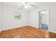 Bright bedroom with hardwood floors, white walls, and a window, offering a serene and inviting atmosphere at 1402 E Mimosa Dr, Plant City, FL 33563