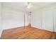 Bright bedroom with hardwood floors, ceiling fan and sliding door closet at 1402 E Mimosa Dr, Plant City, FL 33563
