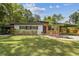 Charming single story home featuring a well maintained lawn and a covered carport at 1402 E Mimosa Dr, Plant City, FL 33563