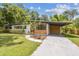 Charming single story home featuring a well maintained lawn and a covered carport at 1402 E Mimosa Dr, Plant City, FL 33563