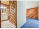 Hallway with view of bathroom and paneled living room at 1402 E Mimosa Dr, Plant City, FL 33563
