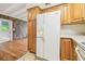Bright kitchen with wood cabinets, tile floors and a white refrigerator at 1402 E Mimosa Dr, Plant City, FL 33563