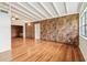 Spacious living room featuring hardwood floors and a unique wood accent wall at 1402 E Mimosa Dr, Plant City, FL 33563