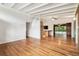 Open floor plan with hardwood floors featuring kitchen and pool views at 1402 E Mimosa Dr, Plant City, FL 33563