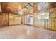Paneled living room with tile floors, ceiling fan, and a built in bookshelf at 1402 E Mimosa Dr, Plant City, FL 33563