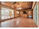 Paneled living room with tile floors, ceiling fan, and a view of the kitchen at 1402 E Mimosa Dr, Plant City, FL 33563