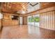 Paneled living room with tile floors, ceiling fan, and a view of the pool at 1402 E Mimosa Dr, Plant City, FL 33563