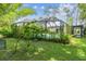 Landscaped backyard features a screened-in pool with a patio and green grass at 1402 E Mimosa Dr, Plant City, FL 33563