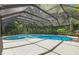 Inviting screened pool with blue water, surrounded by lush greenery, offering a private oasis at 1402 E Mimosa Dr, Plant City, FL 33563