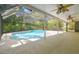 Screened pool featuring a patio, beautiful landscaping, and ample space for relaxation and entertainment at 1402 E Mimosa Dr, Plant City, FL 33563