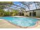 Backyard pool with a brick trim, open patio, and screened enclosure, perfect for outdoor enjoyment at 1402 E Mimosa Dr, Plant City, FL 33563
