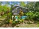Secluded pool surrounded by lush greenery and tropical plants; backyard oasis at 1402 E Mimosa Dr, Plant City, FL 33563
